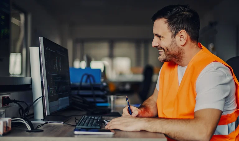 foreman sitting at his desk in front of a monitor