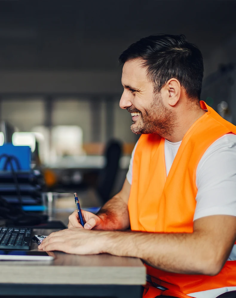 foreman sitting at his desk in front of a laptop